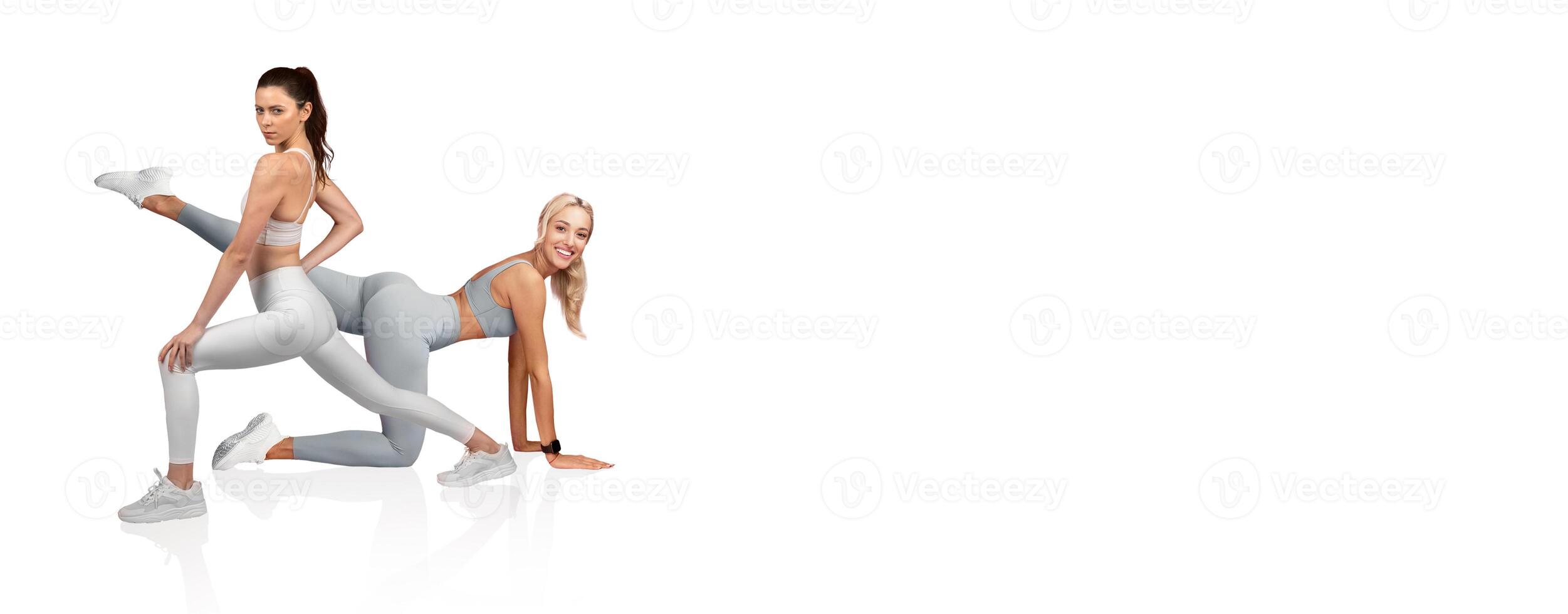 Two fitness models display dynamic workout poses in matching light gray athletic outfits. The setting highlights their strength and flexibility, promoting a healthy lifestyle. photo