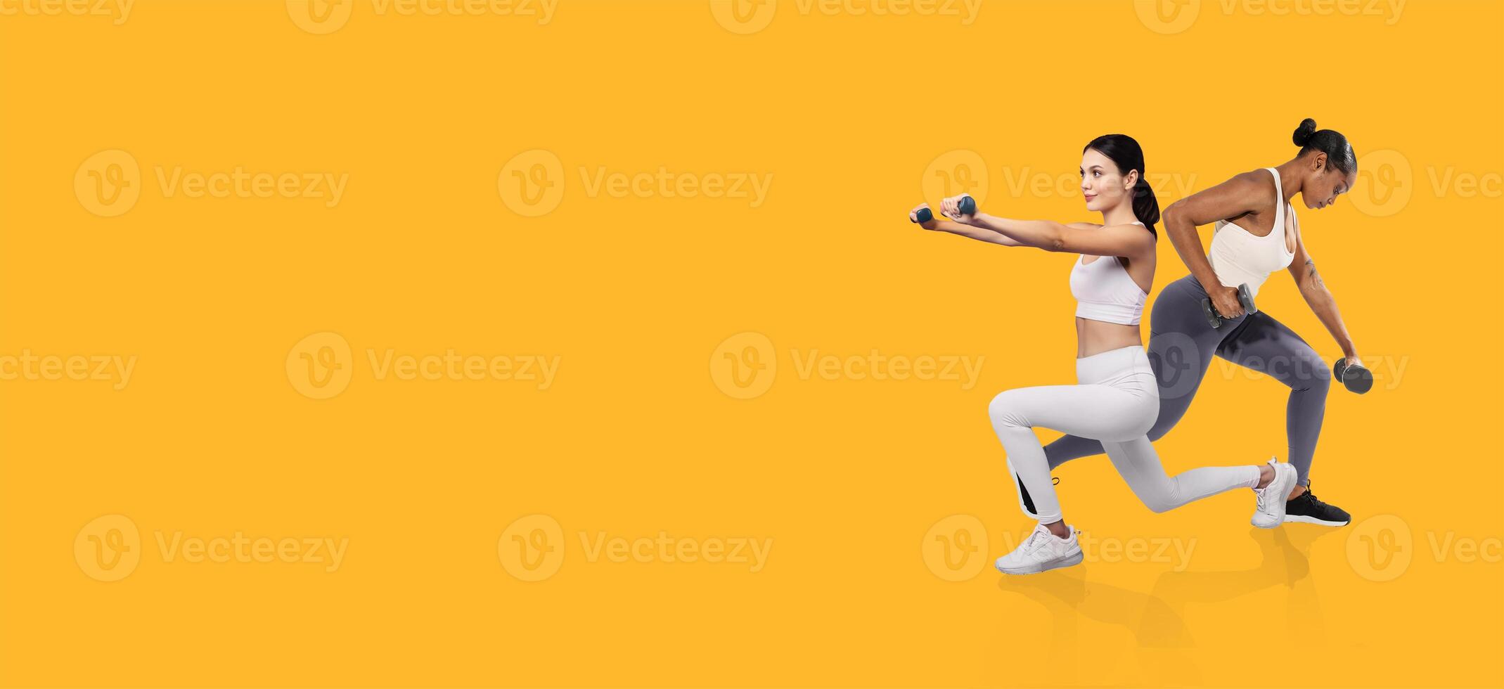 Two women perform strength training exercises using dumbbells in a bright indoor space. They focus on their routines with determination and concentration, showcasing a healthy lifestyle. photo