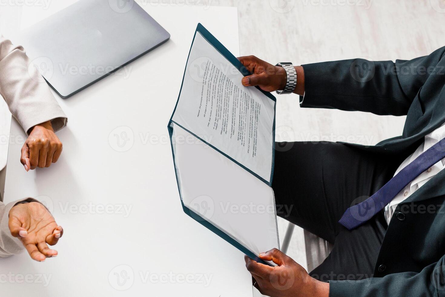 Hiring manager with CV and vacancy candidate on job interview at company office, above view. Empty space photo