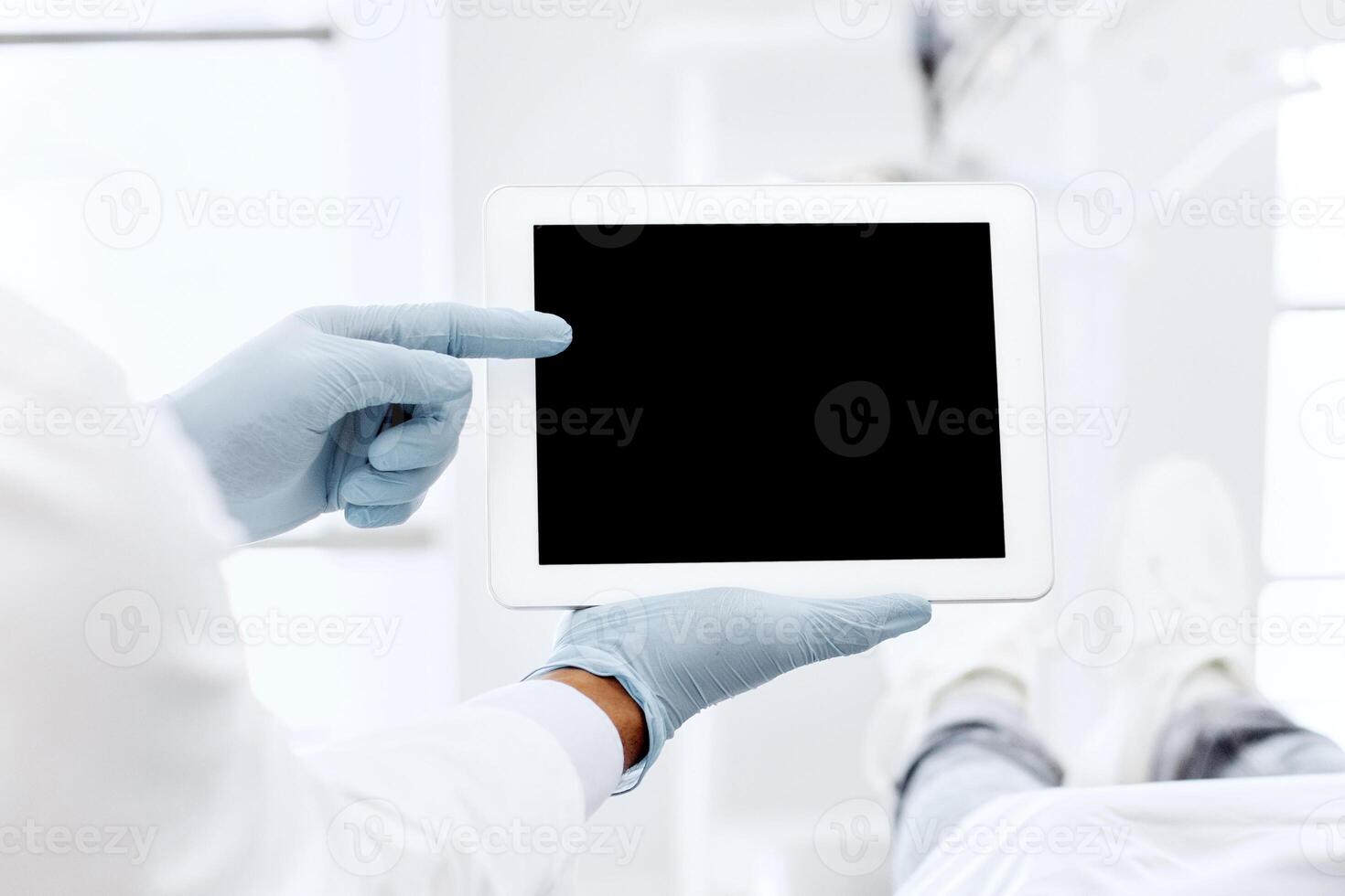 Black Dentist Showing Digital Tablet With Blank Screen To Female Patient During Check Up In Modern Stomatological Clinic, Demonstrating Dental Treatment Result Or Teeth X-Ray On Modern Gadget, Mockup photo