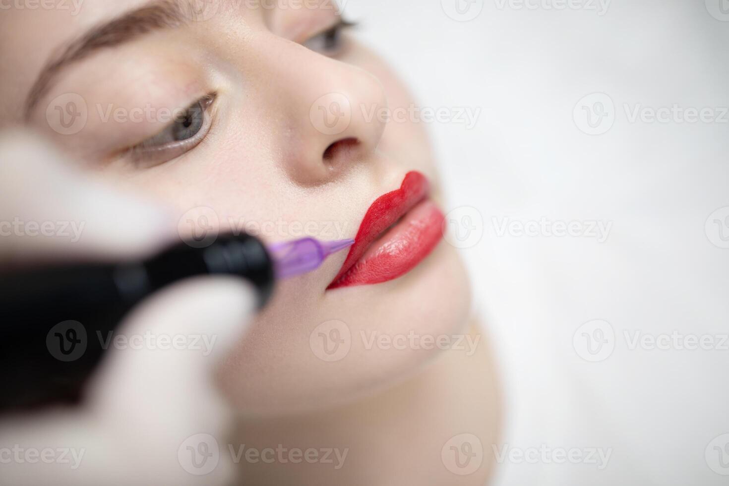 A skilled technician applies a long-lasting lip color to a client's lips in a modern salon, showcasing the artistry of permanent makeup and the pampering experience involved. photo