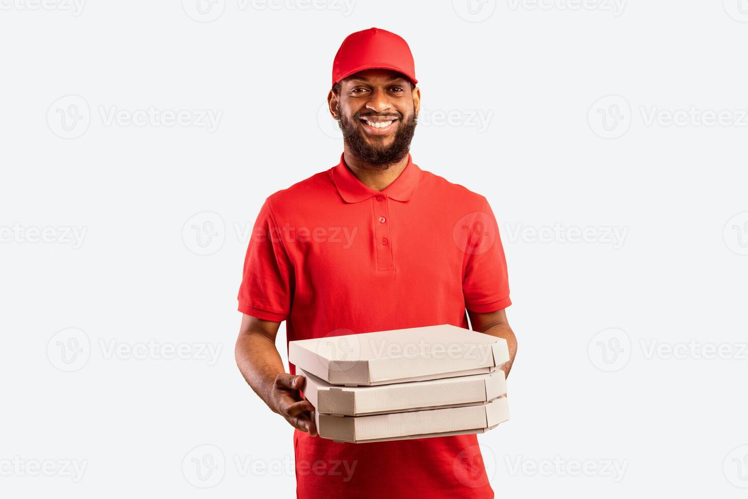 Pizza Delivery. Black Pizzeria Worker Courier Man Delivering Pizza Holding Boxes Standing On Yellow Studio Background. photo