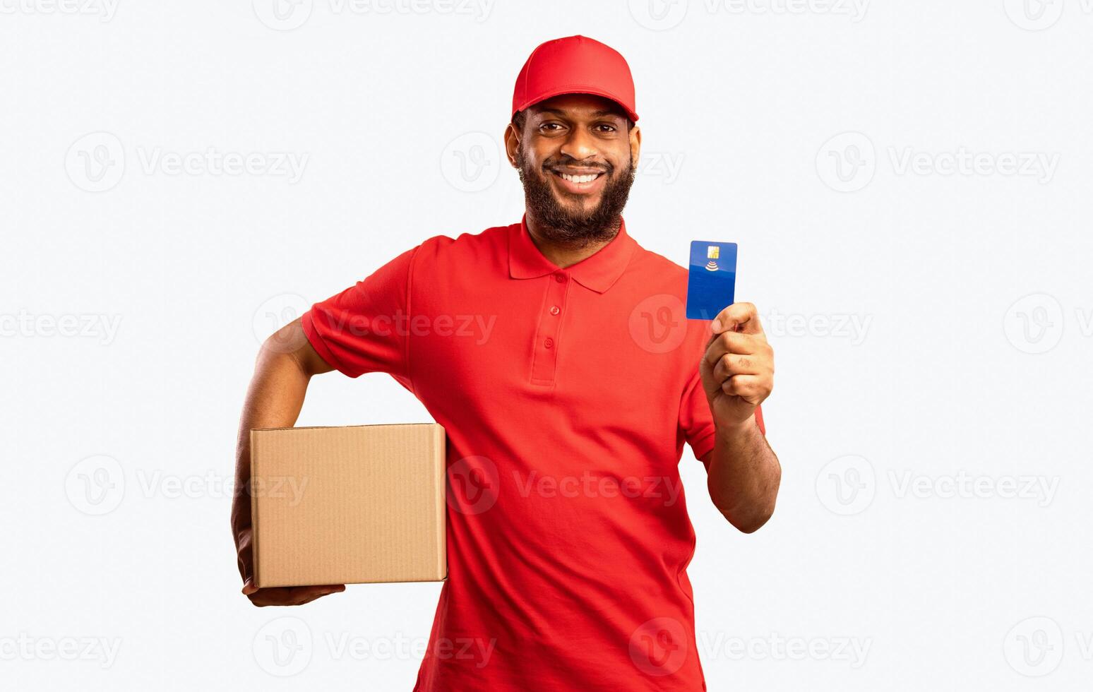 Safe Delivery. Courier man holding contactless payment credit card delivering parcel box standing over yellow studio background photo