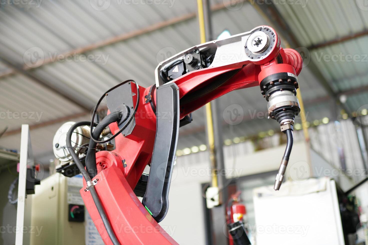 A close up of a robot arm in a factory photo