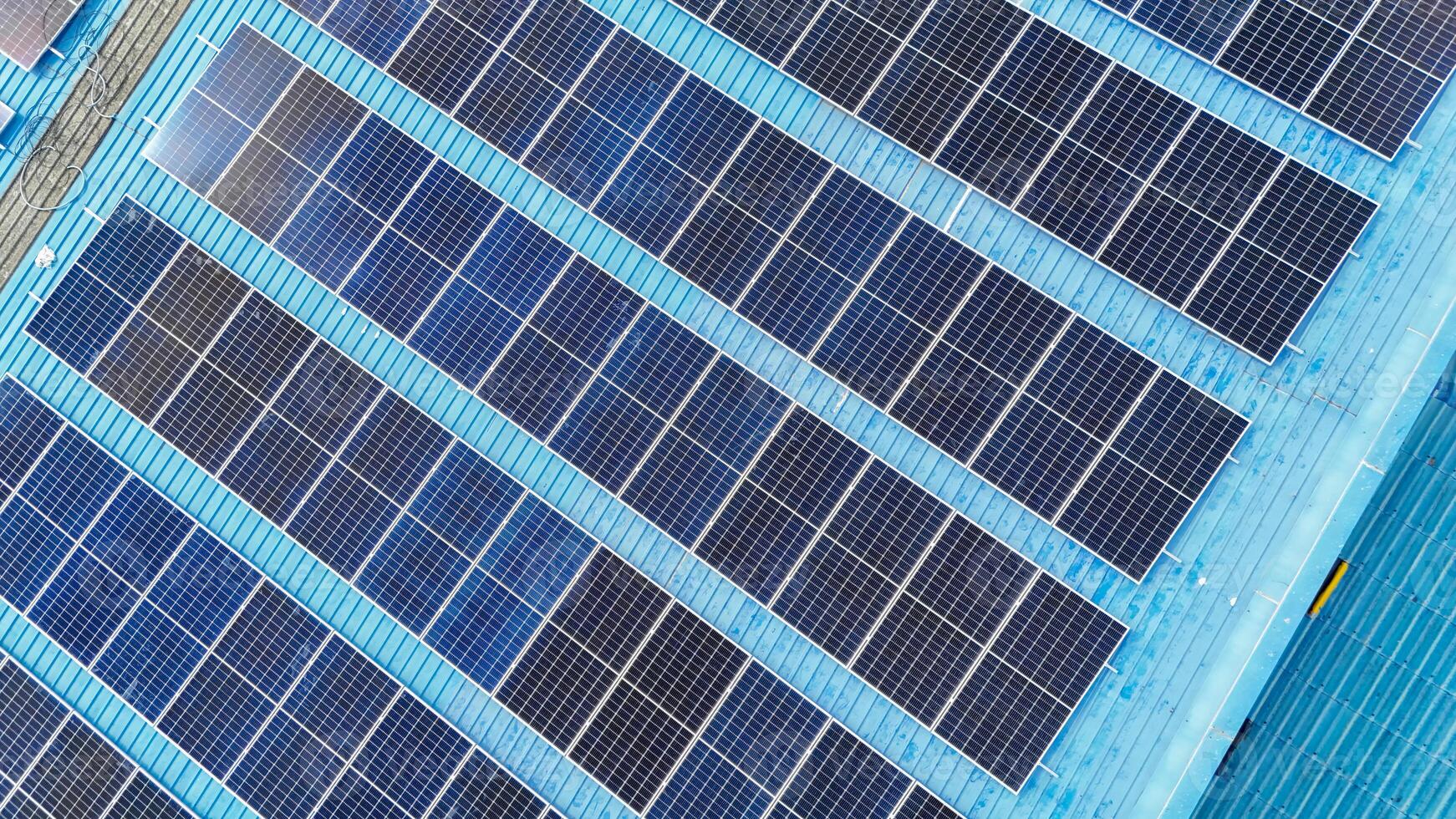 A blue building with solar panels on it photo