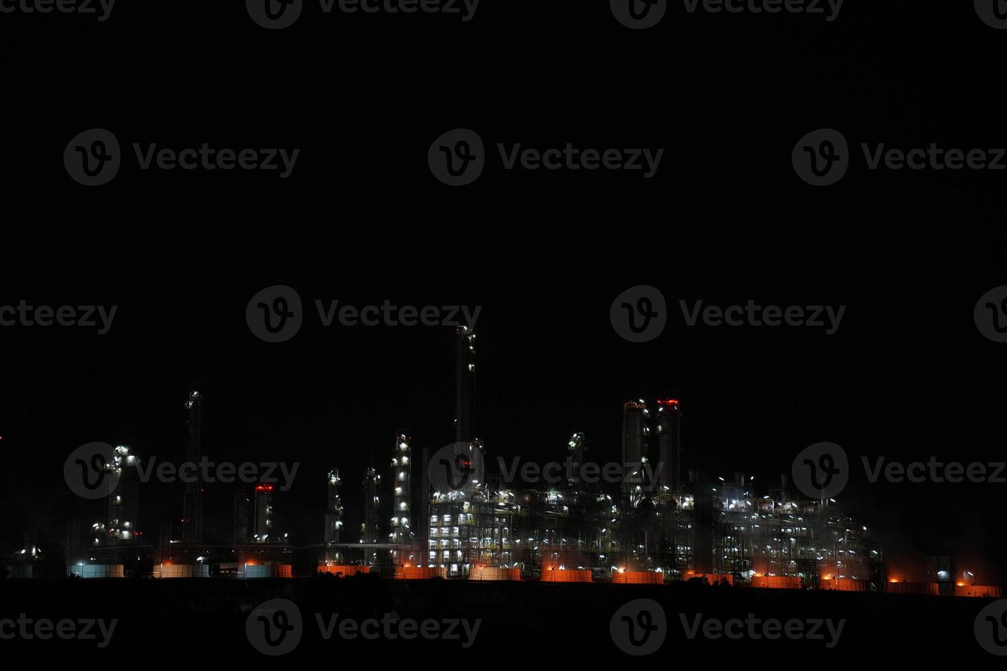 A large oil refinery at night with many lights photo