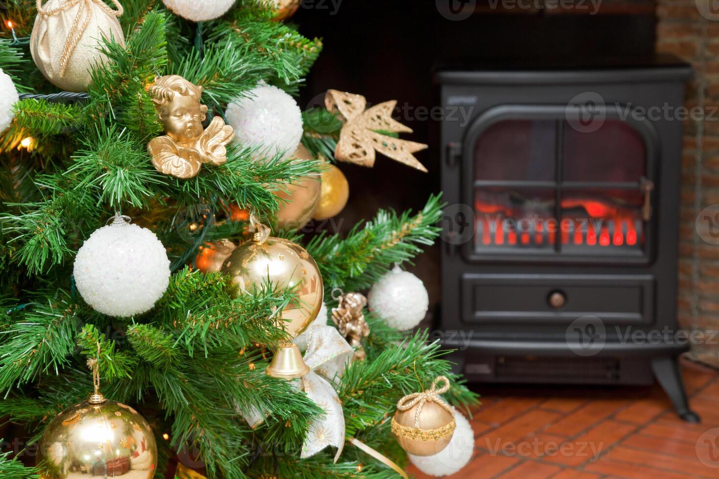 Christmas decorations on a tree with the bottom of a fireplace photo