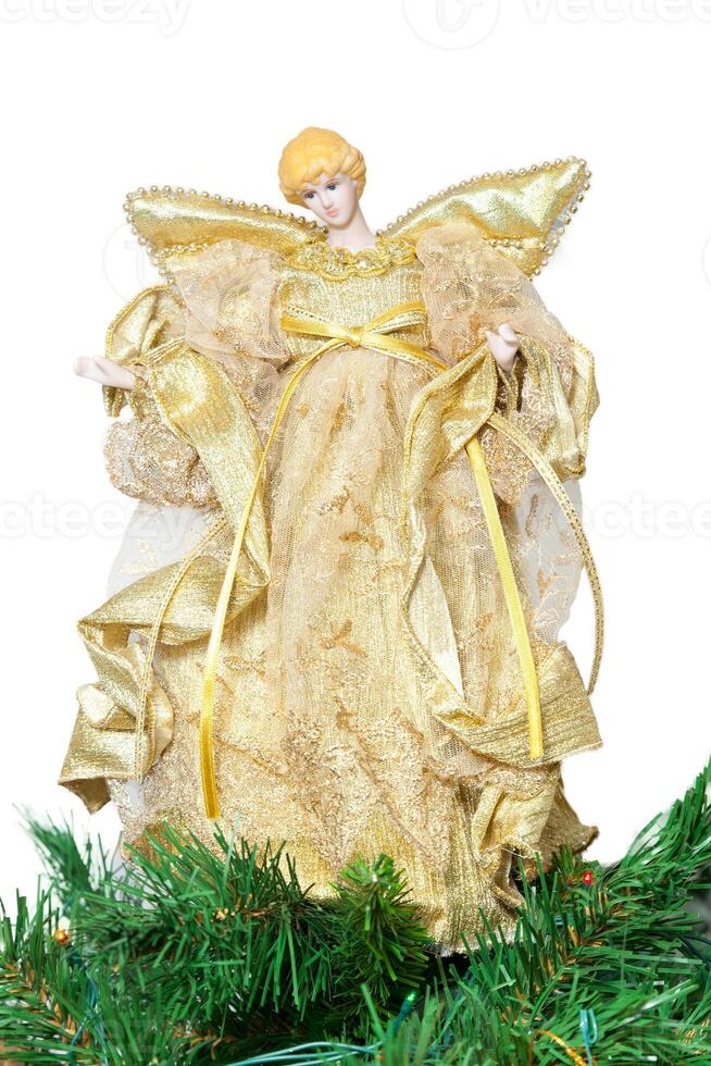 Tip in the shape of angel on top of the Christmas tree photo