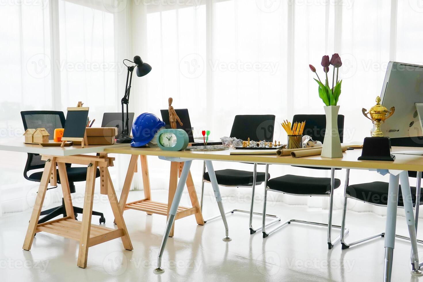 An office with a desk, chairs and a computer photo