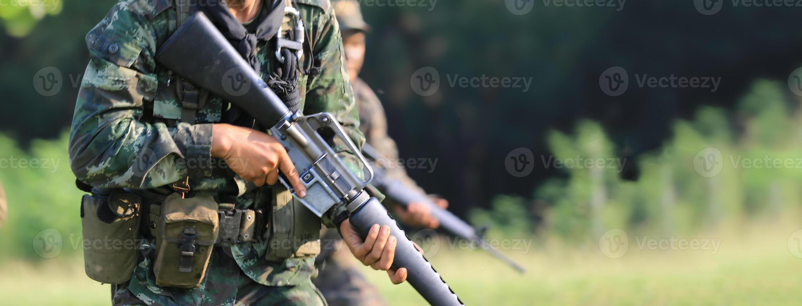 A soldier with a rifle in the field photo