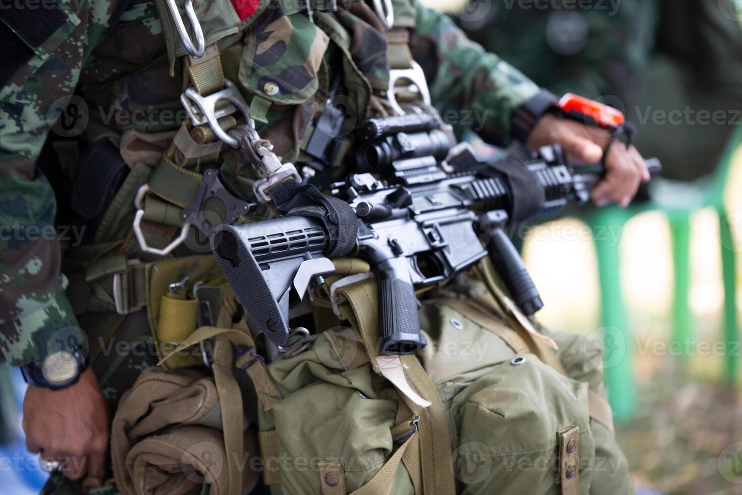 A soldier with an ak - 47 rifle and a backpack photo