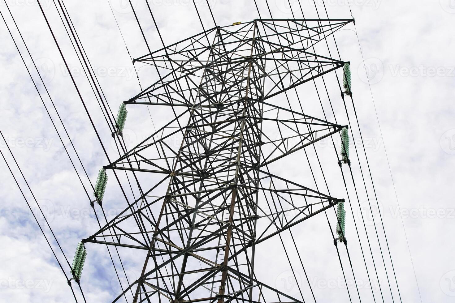 A high voltage power line with wires and clouds photo