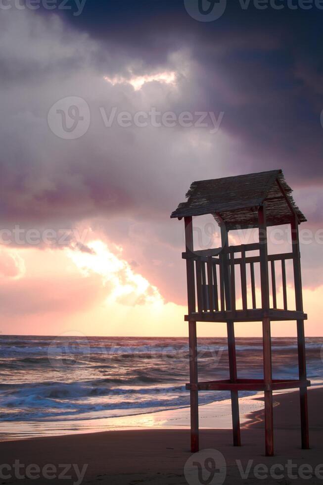 Landscape of beach with the wooden lookout tower photo