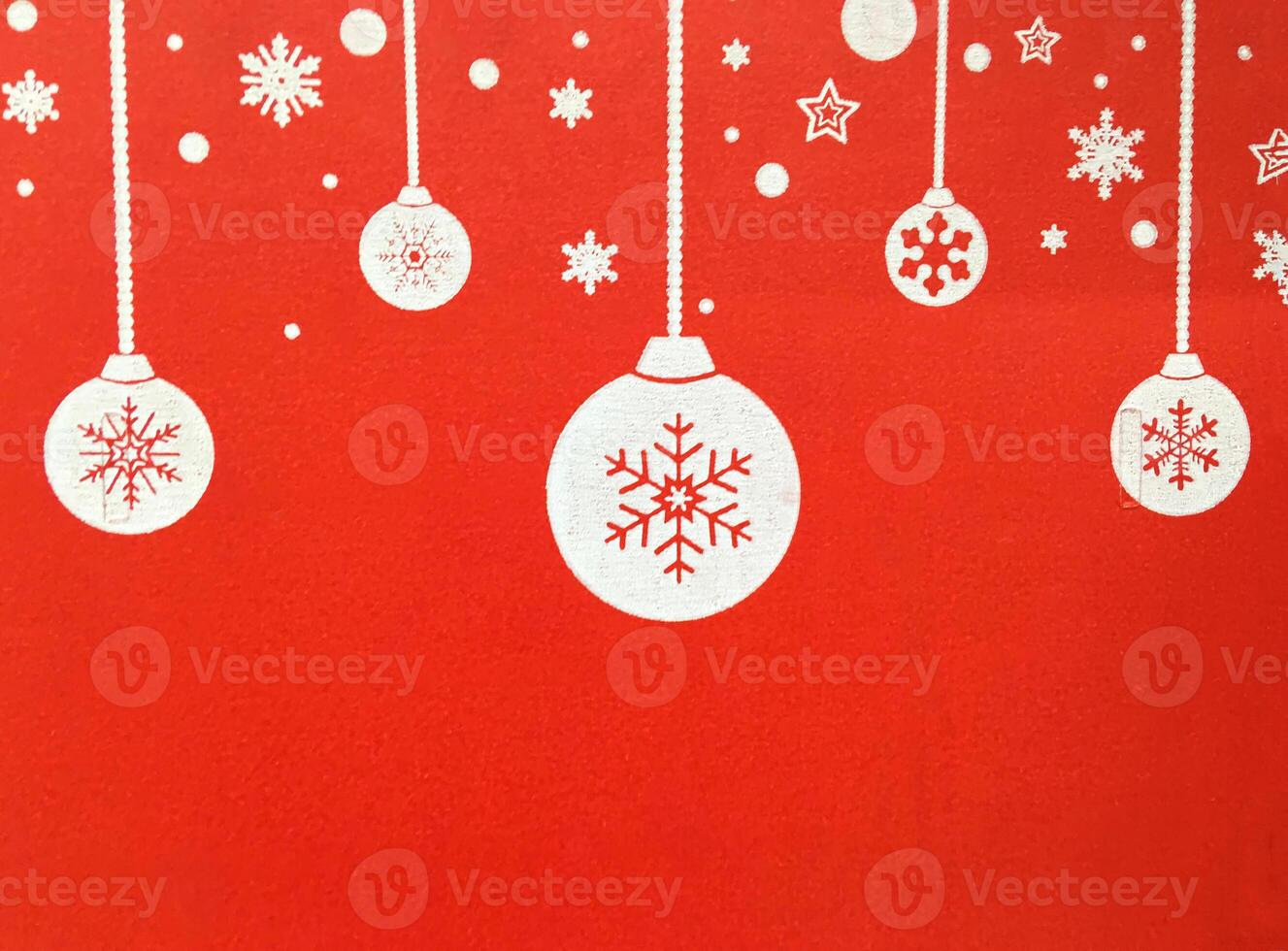 A red wall with a christmas tree and ornaments photo