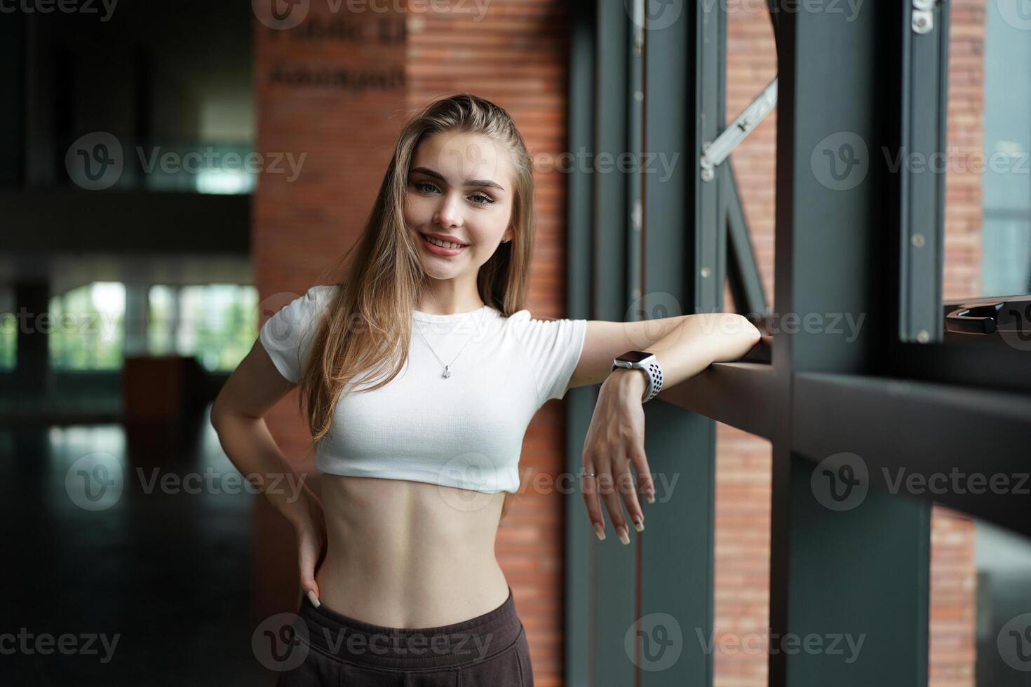 A woman in a white top and black pants photo