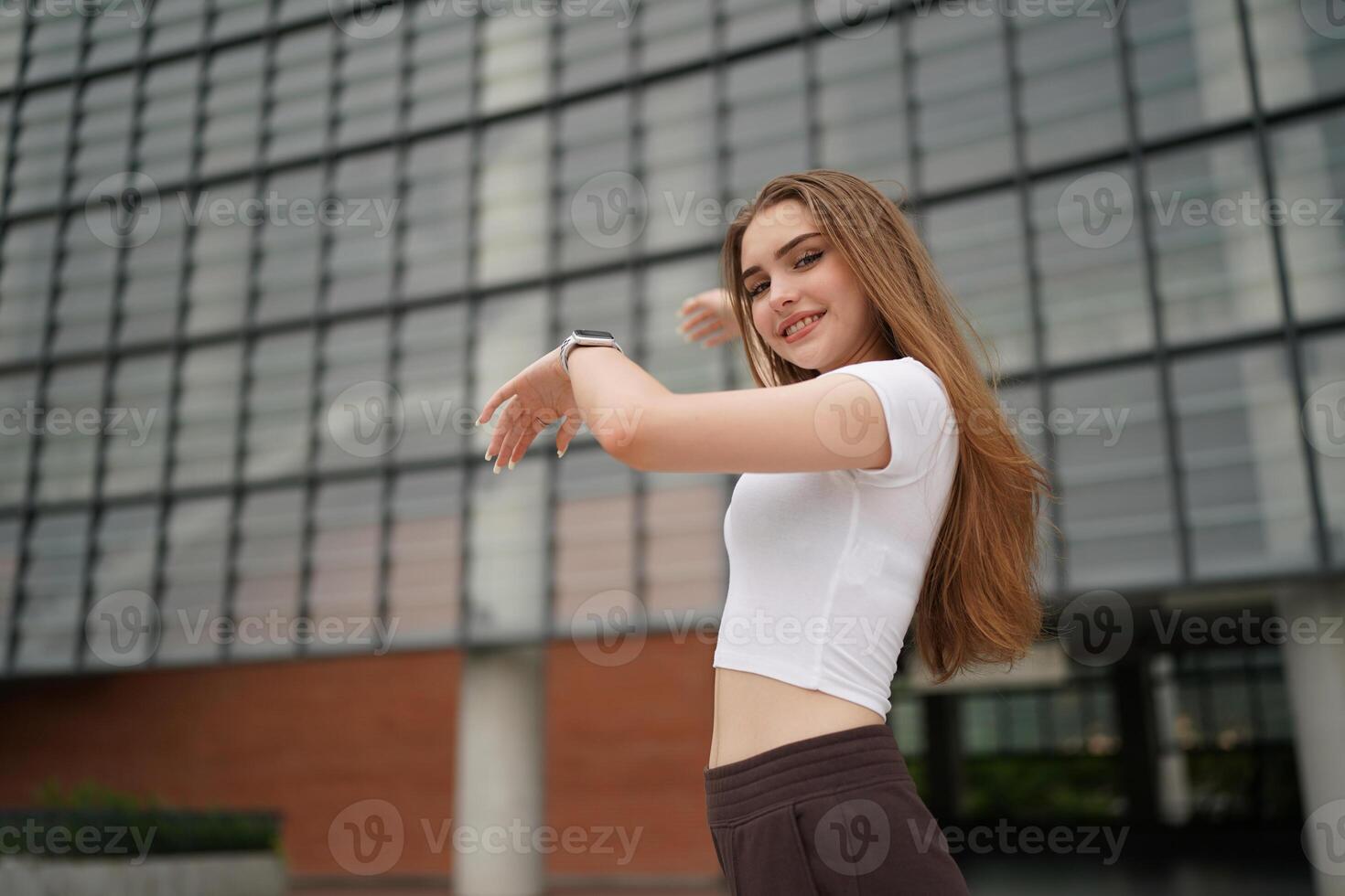 A woman is standing in front of a building photo