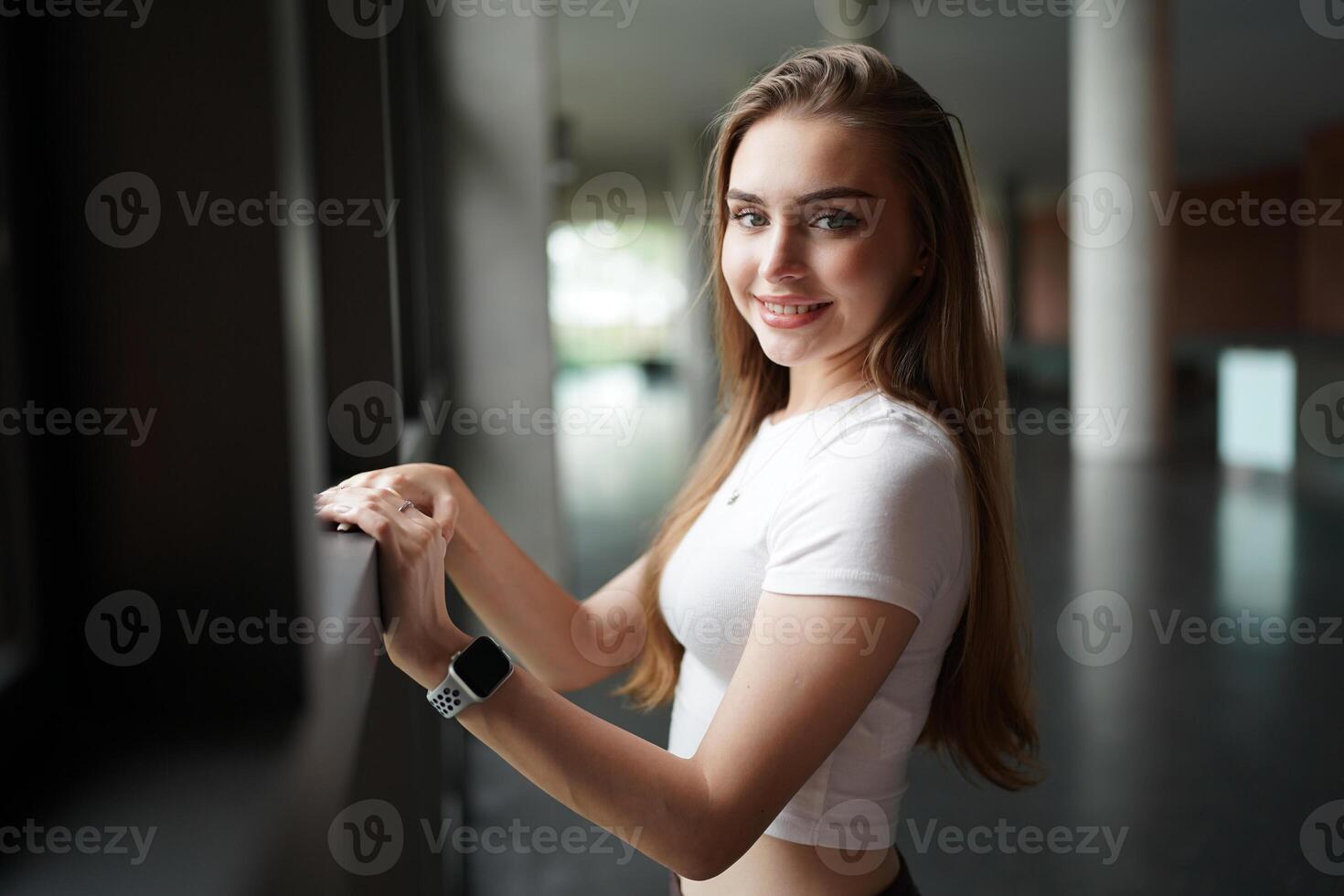 A woman is standing in front of a window photo