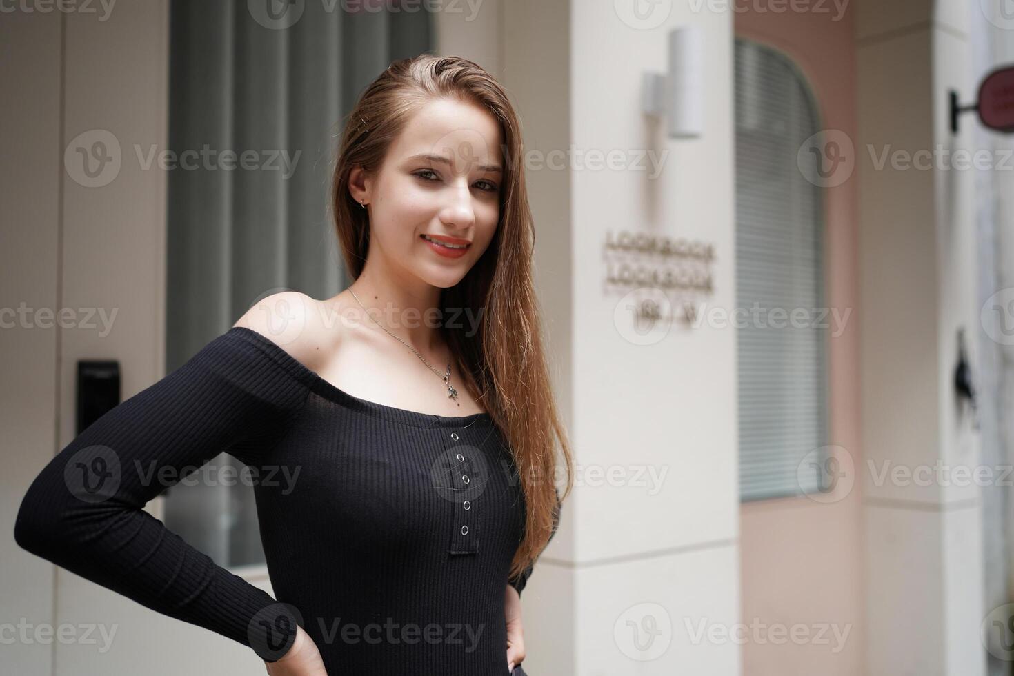 A woman in a black dress posing for a photo