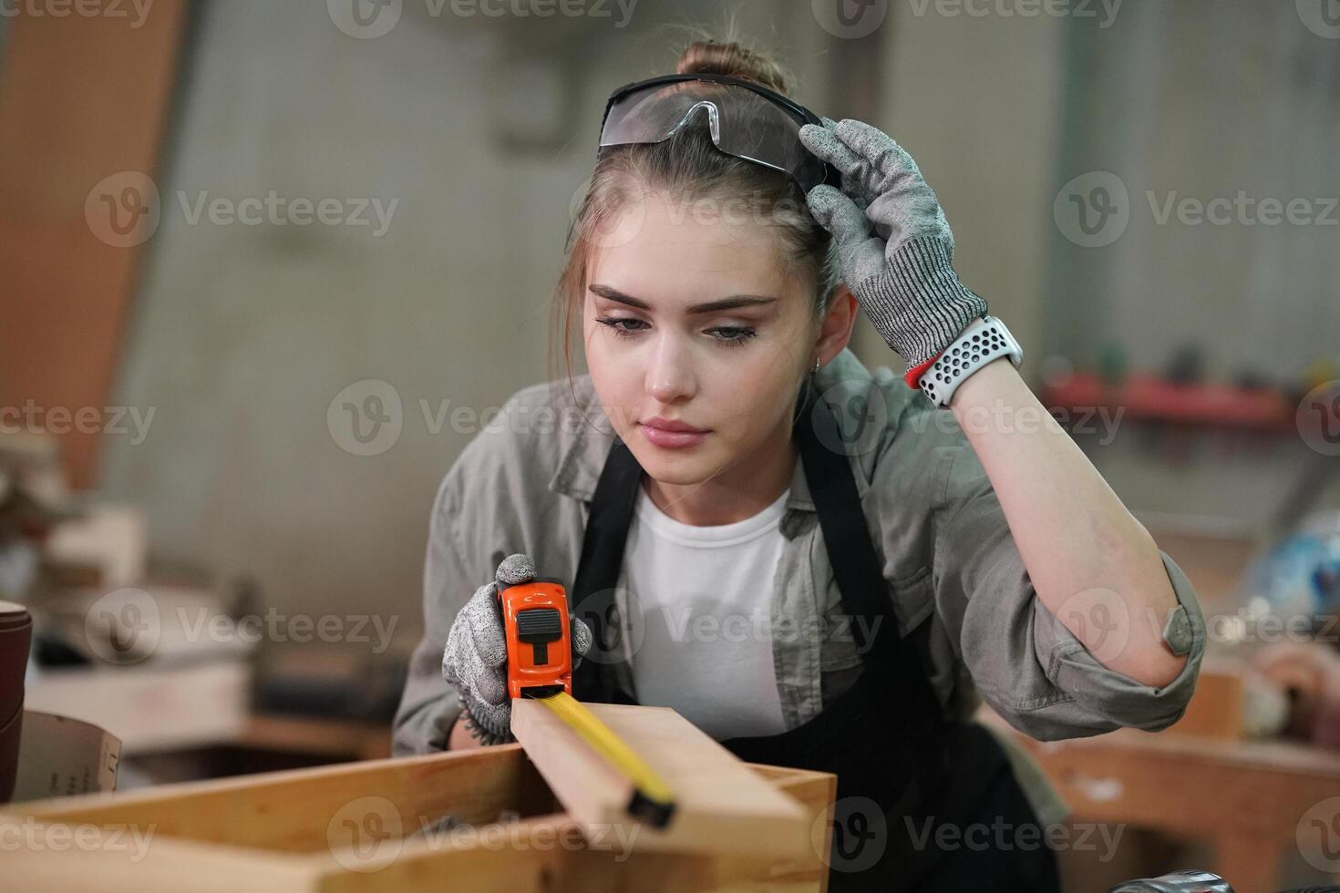 A woman is working on a wooden box photo