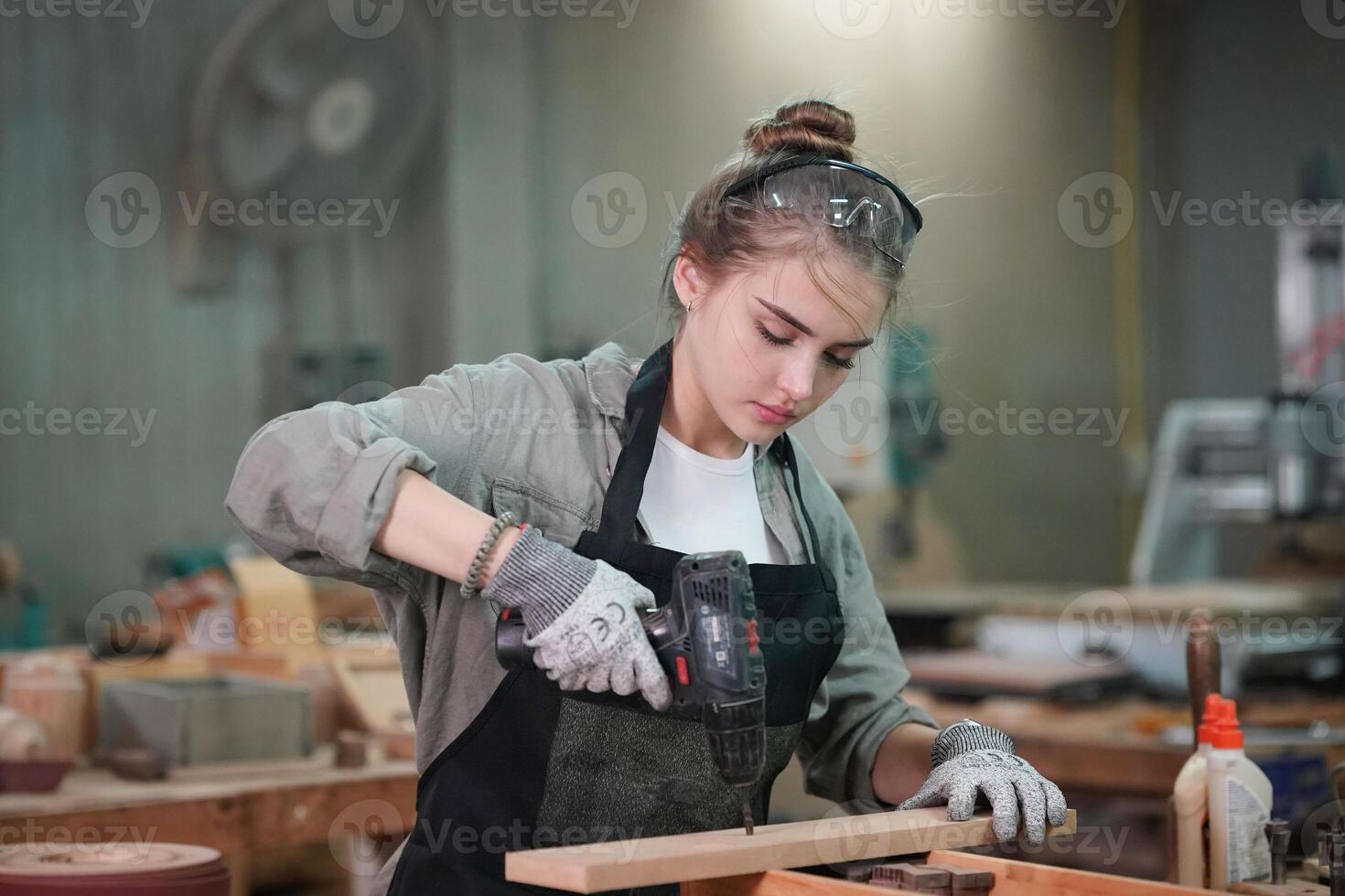 A woman working in a woodworking shop photo