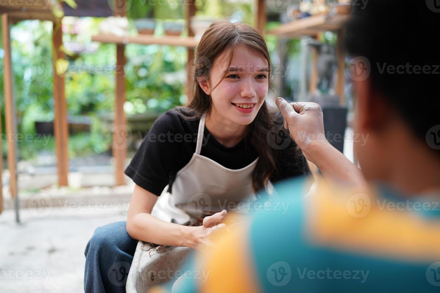 A woman is smiling while holding a cup of coffee photo