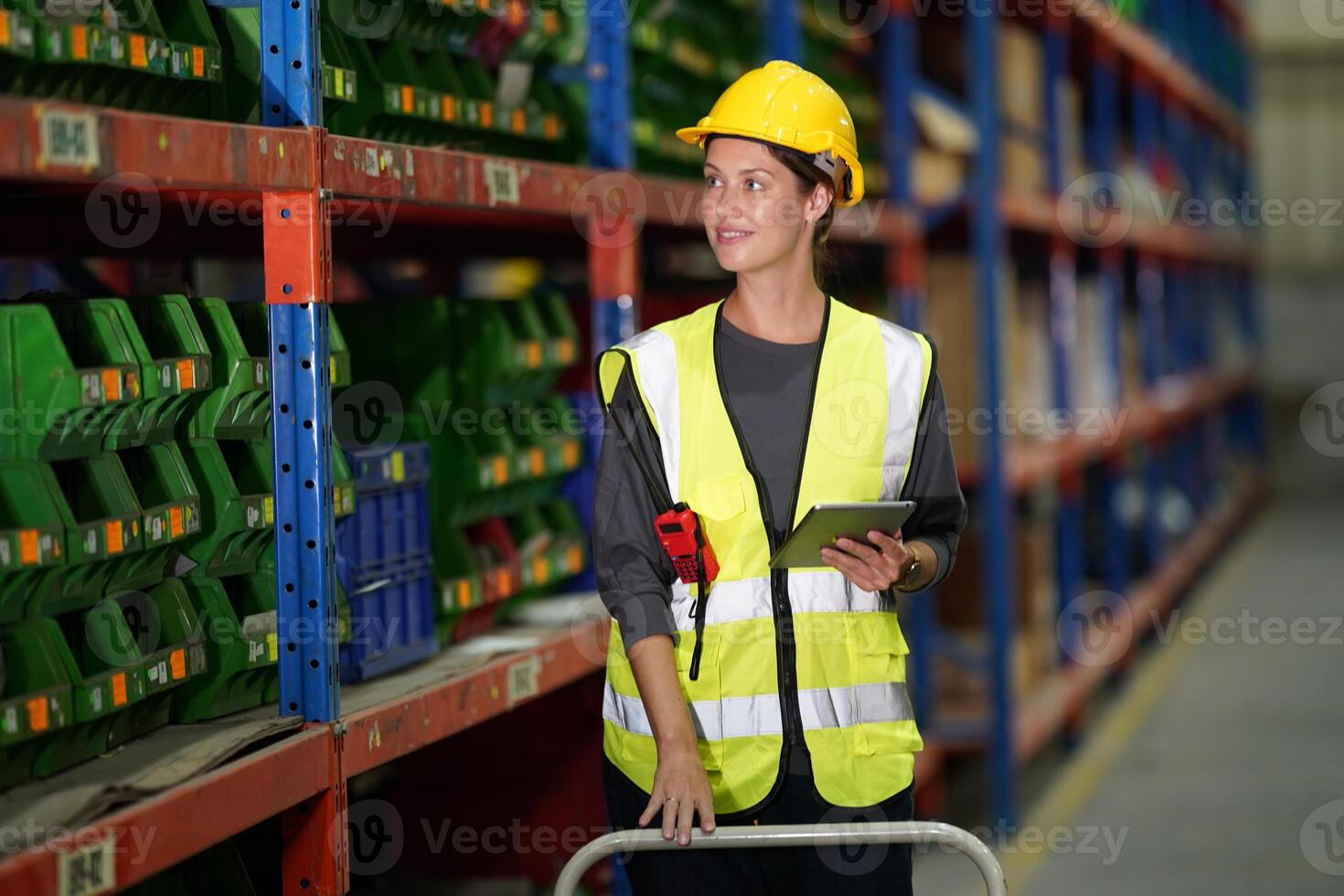 A woman in a safety vest holding a tablet photo