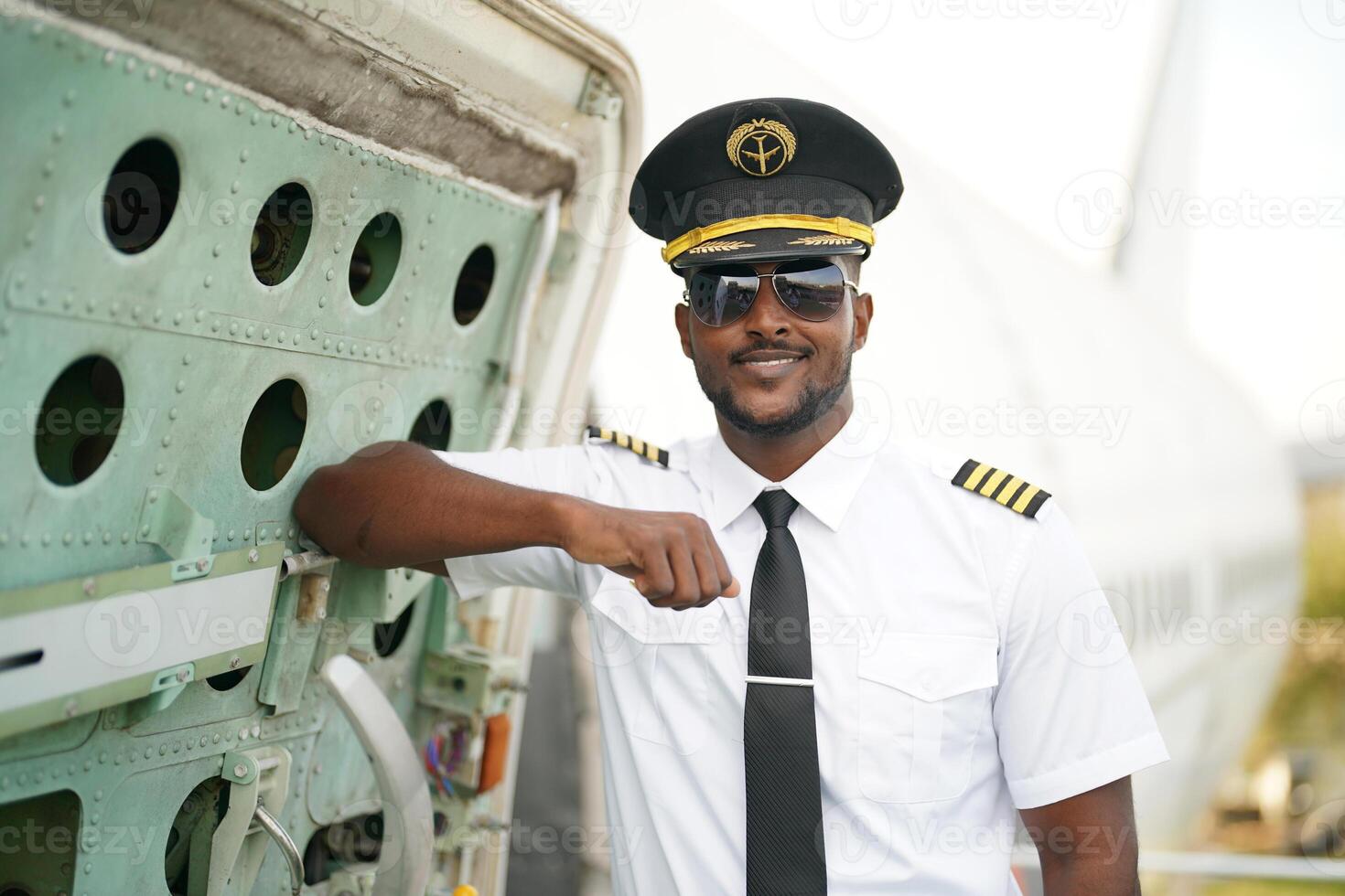 African american pilot in uniform and sunglasses photo