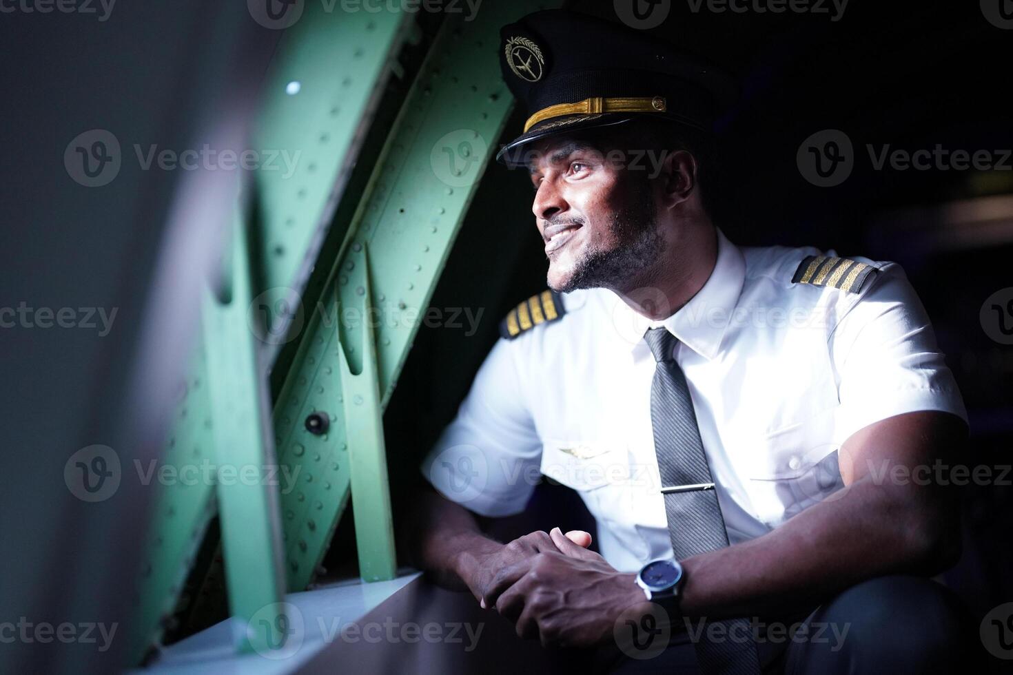 A man in uniform sitting on an airplane photo