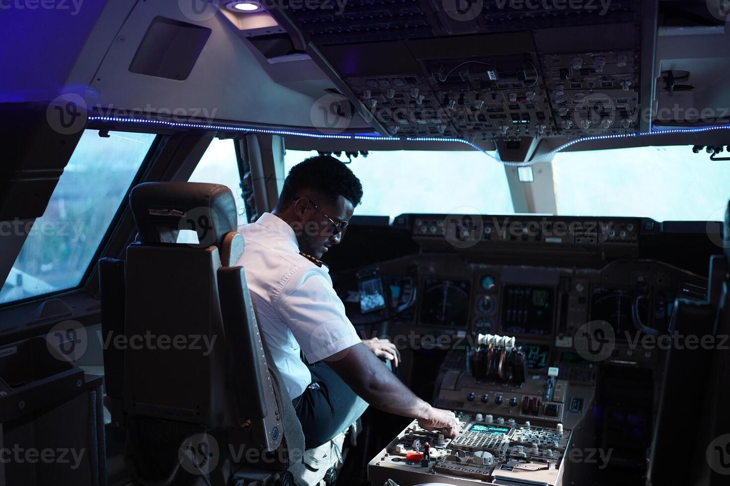 A man in the cockpit of an airplane photo