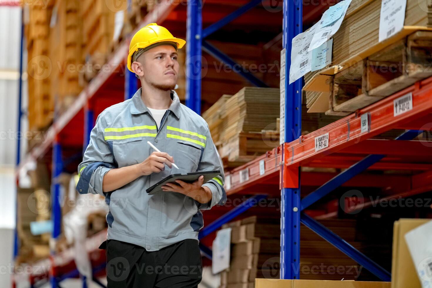 A man in a hard hat standing in a warehouse photo