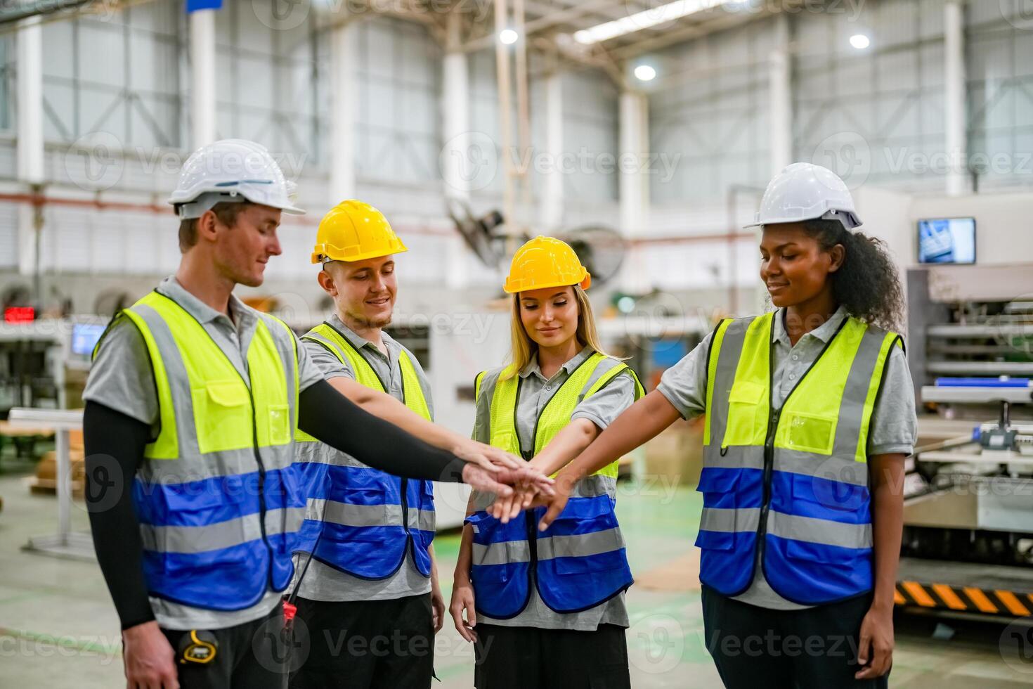 Group of workers shaking hands in factory photo
