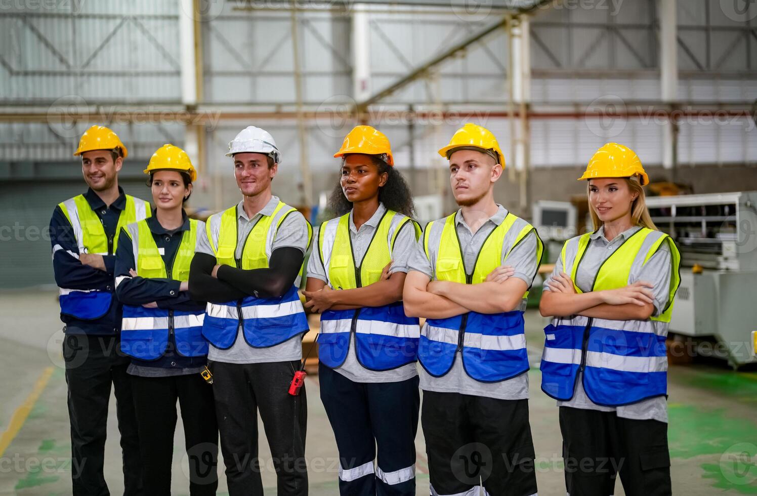 Group of workers standing in factory photo