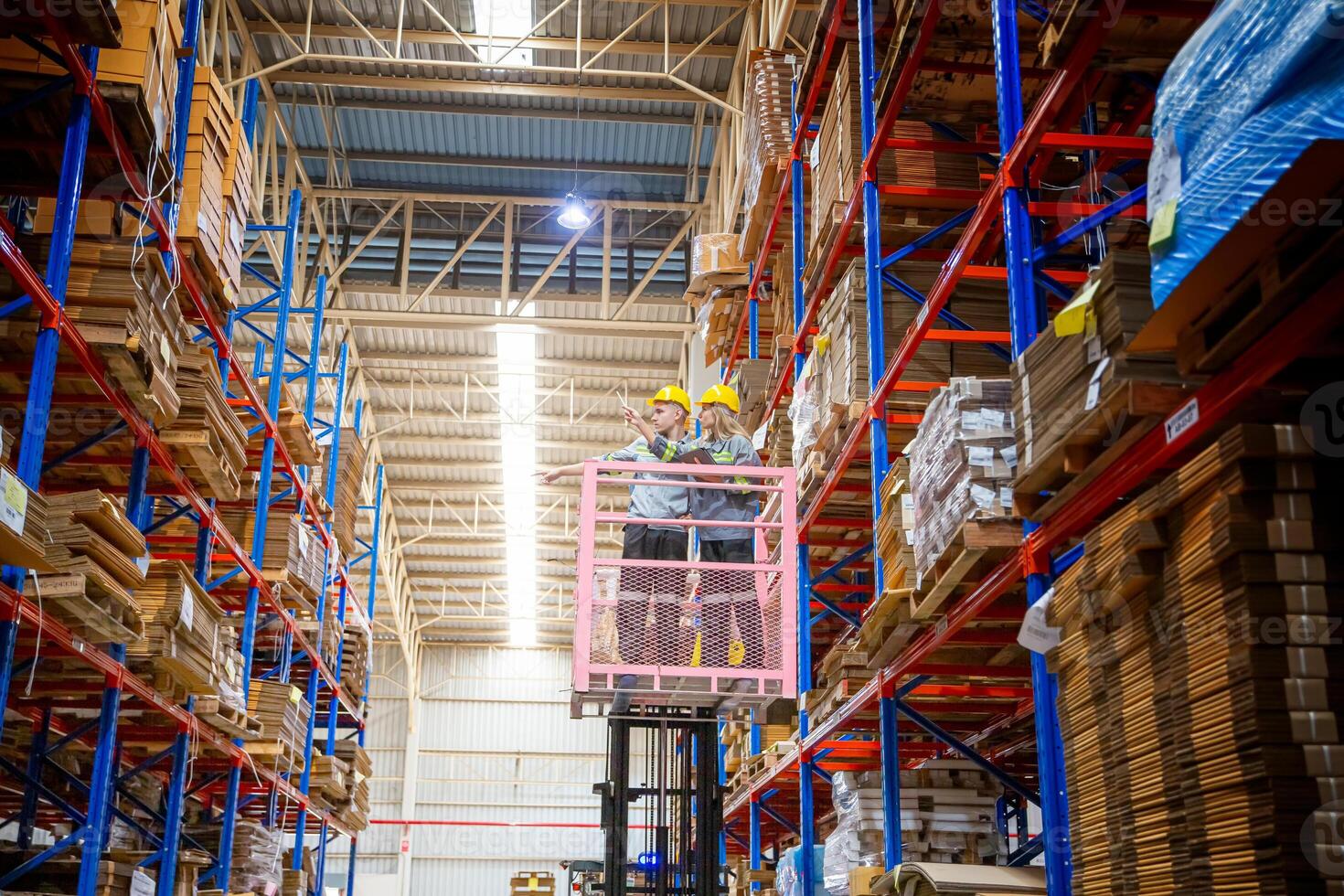 A man on a forklift in a warehouse photo