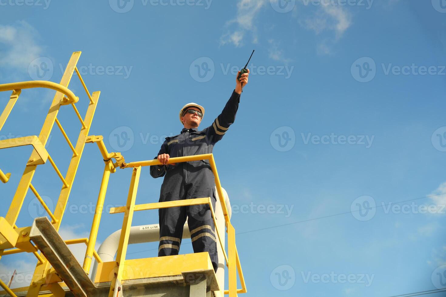 A man on a yellow ladder photo