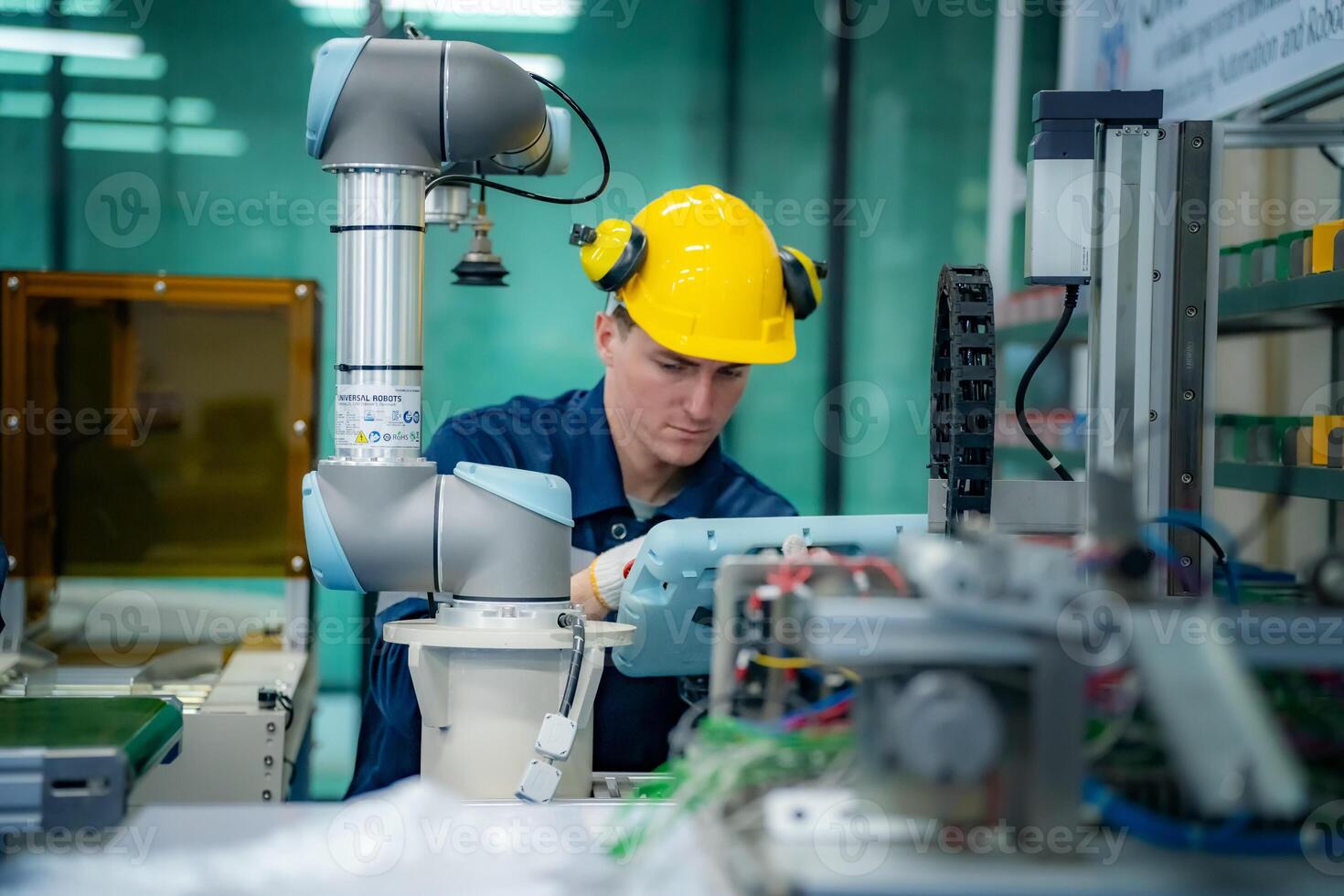 A man in a hard hat working on a machine photo