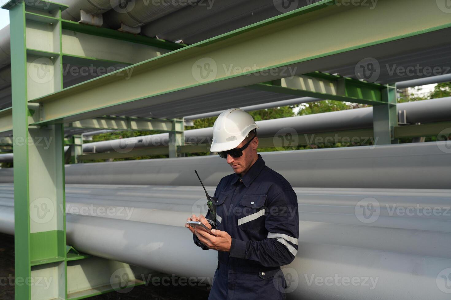 A man in a hard hat and a blue jacket photo