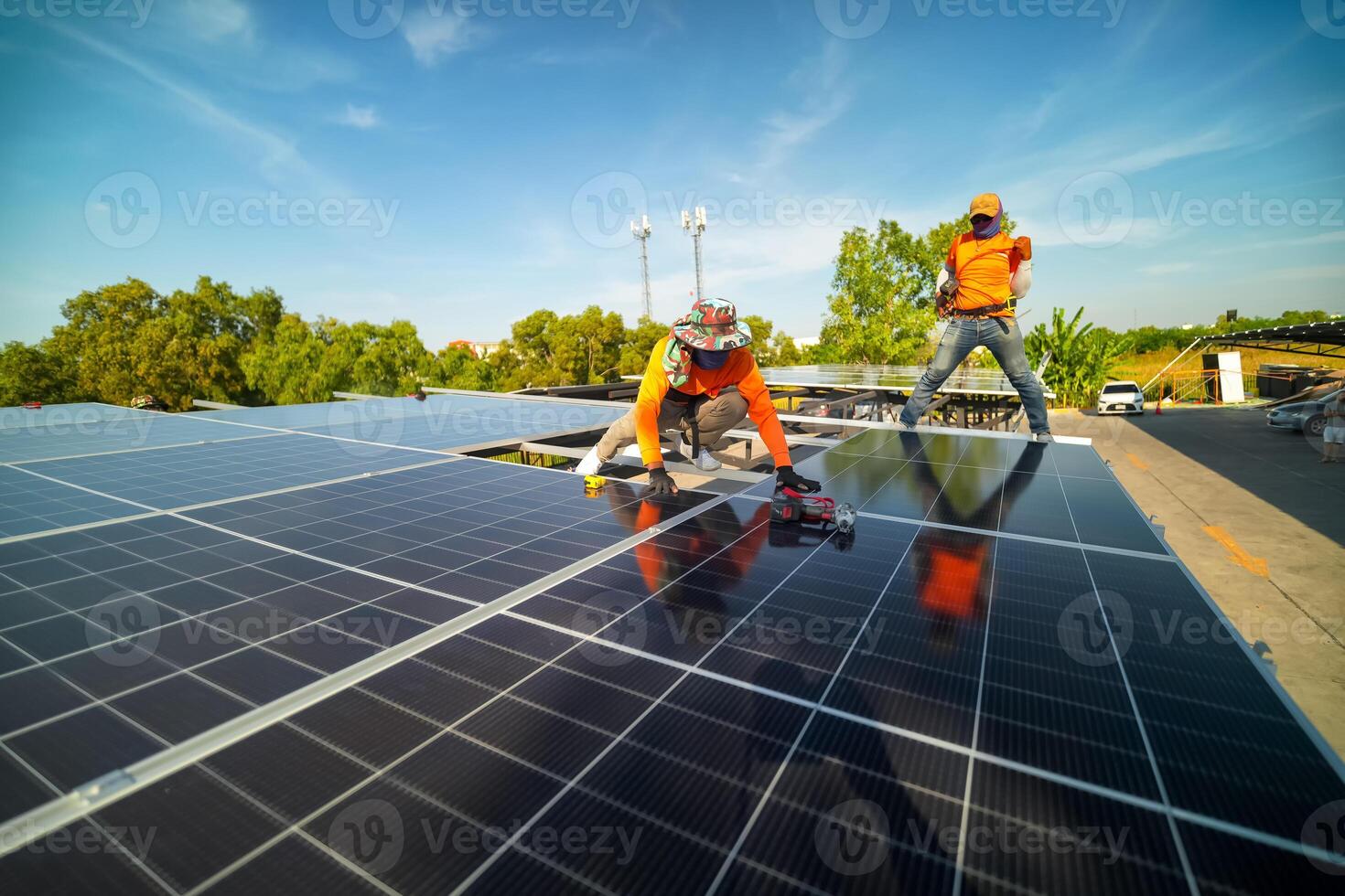 Two men working on a solar panel on a roof photo