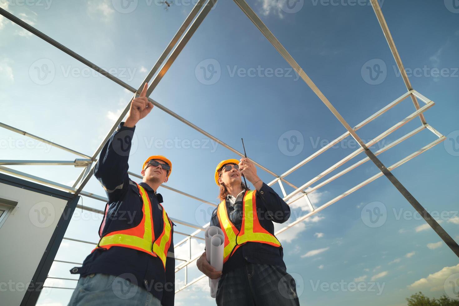 Two surveyor of construction engineer, architect, in hardhat working on construction site. photo