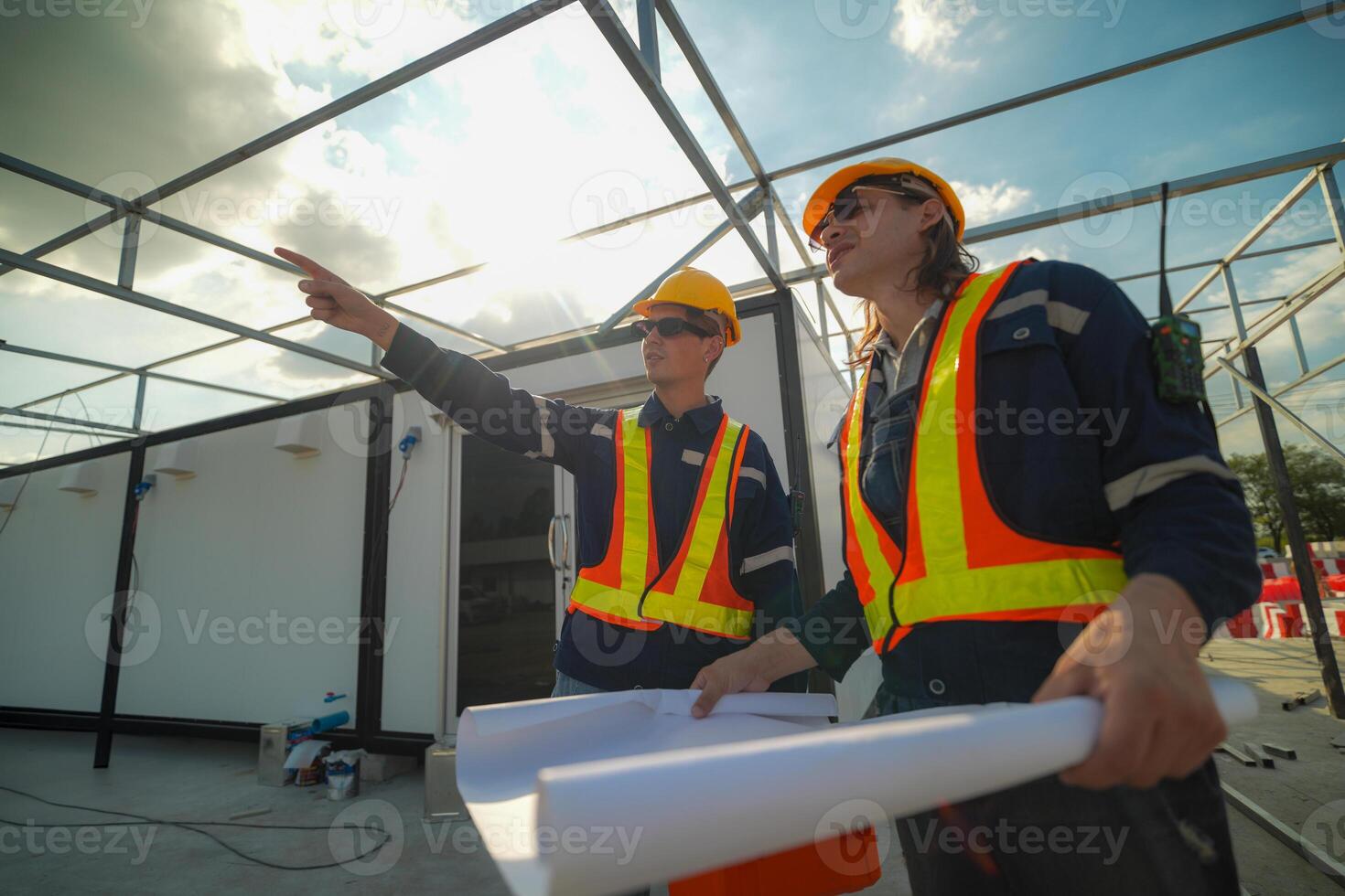 Two surveyor of construction engineer, architect, in hardhat working on construction site. photo