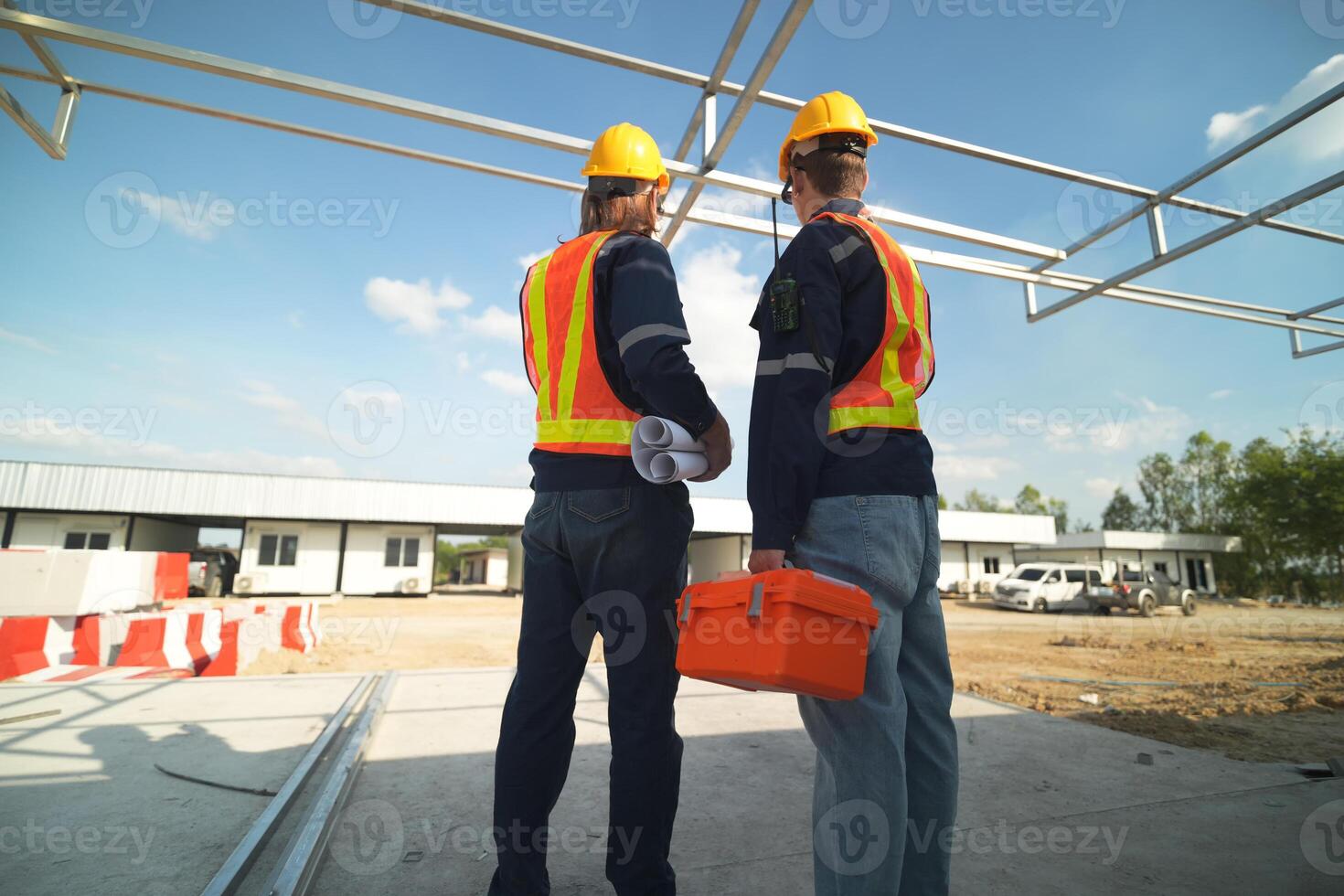 Two surveyor of construction engineer, architect, in hardhat working on construction site. photo