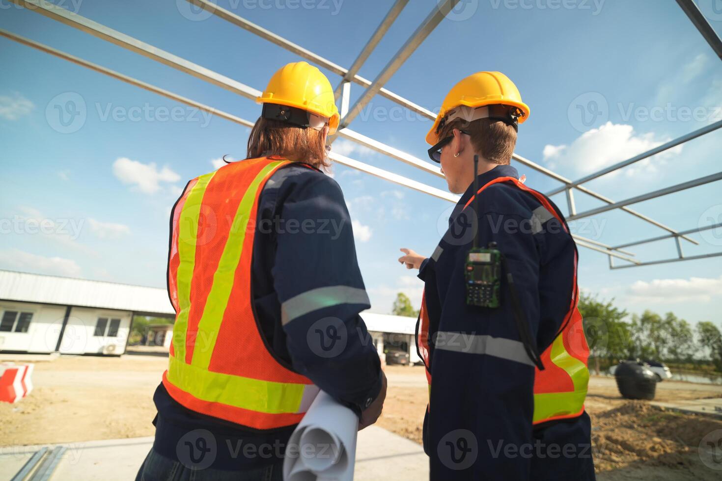 Two surveyor of construction engineer, architect, in hardhat working on construction site. photo