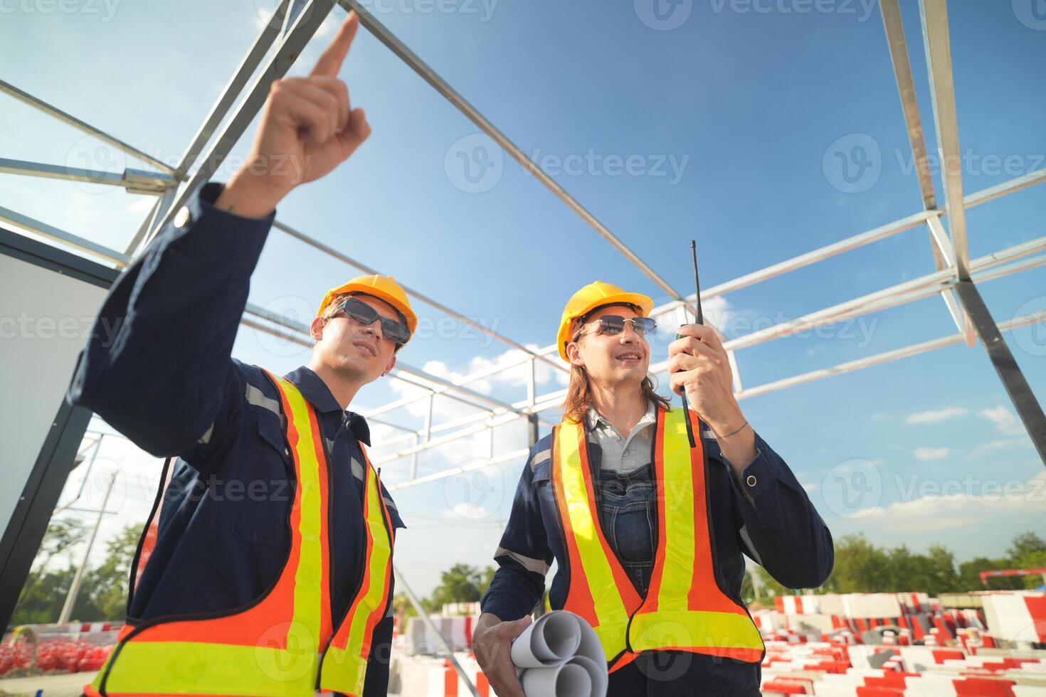 Two surveyor of construction engineer, architect, in hardhat working on construction site. photo