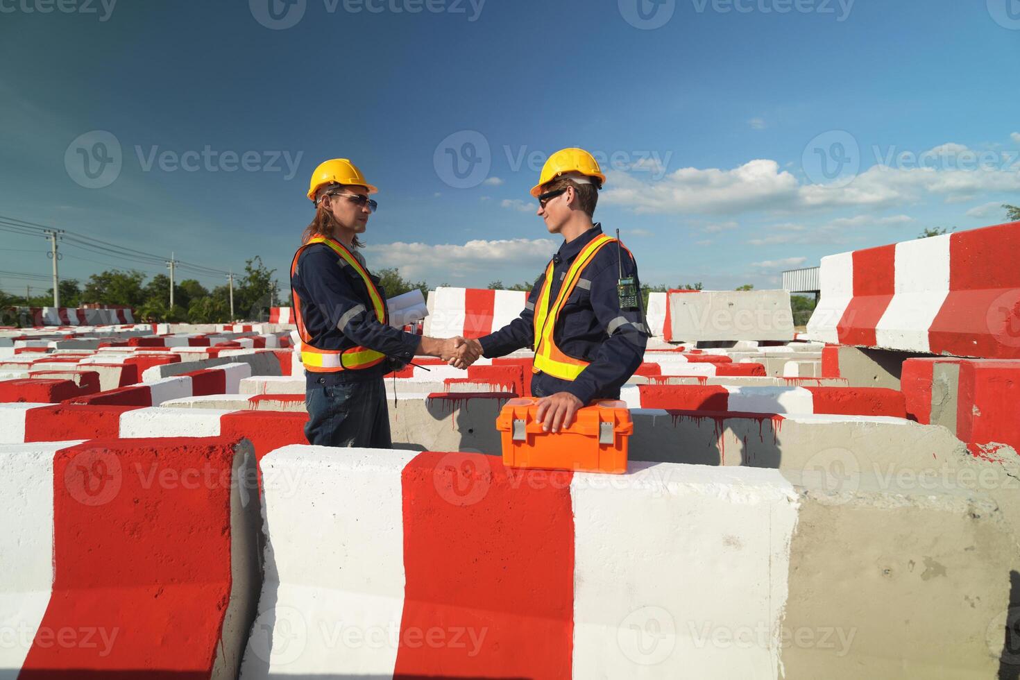 Two surveyor of construction engineer, architect, in hardhat working on construction site. photo