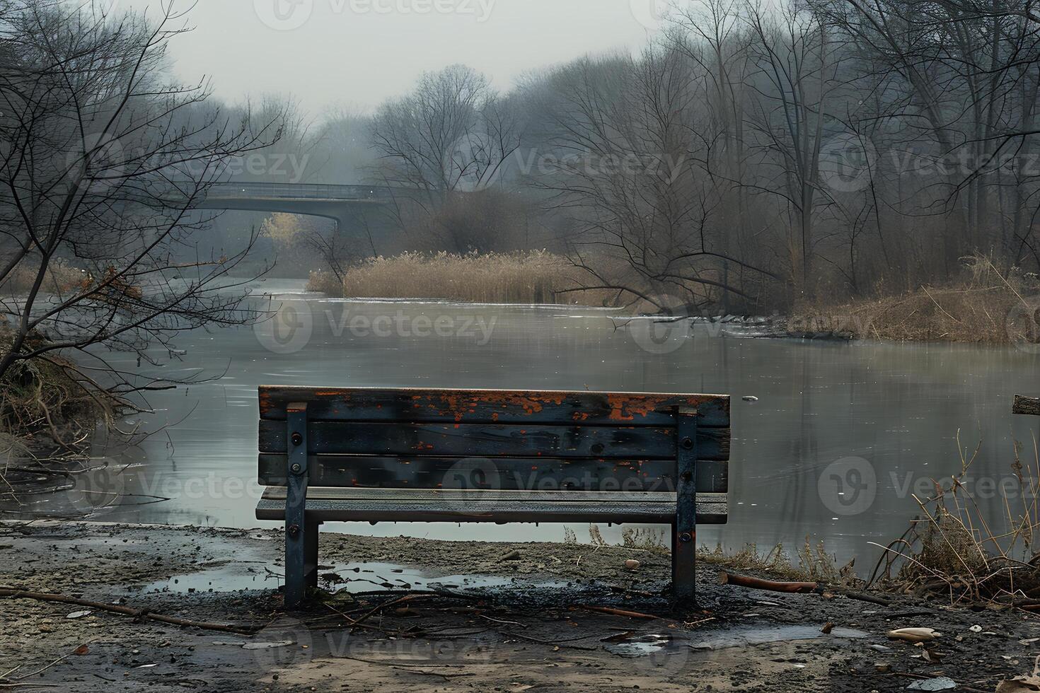 Tranquil Winter Scene with Frozen River and Rustic Bench in Misty Park photo