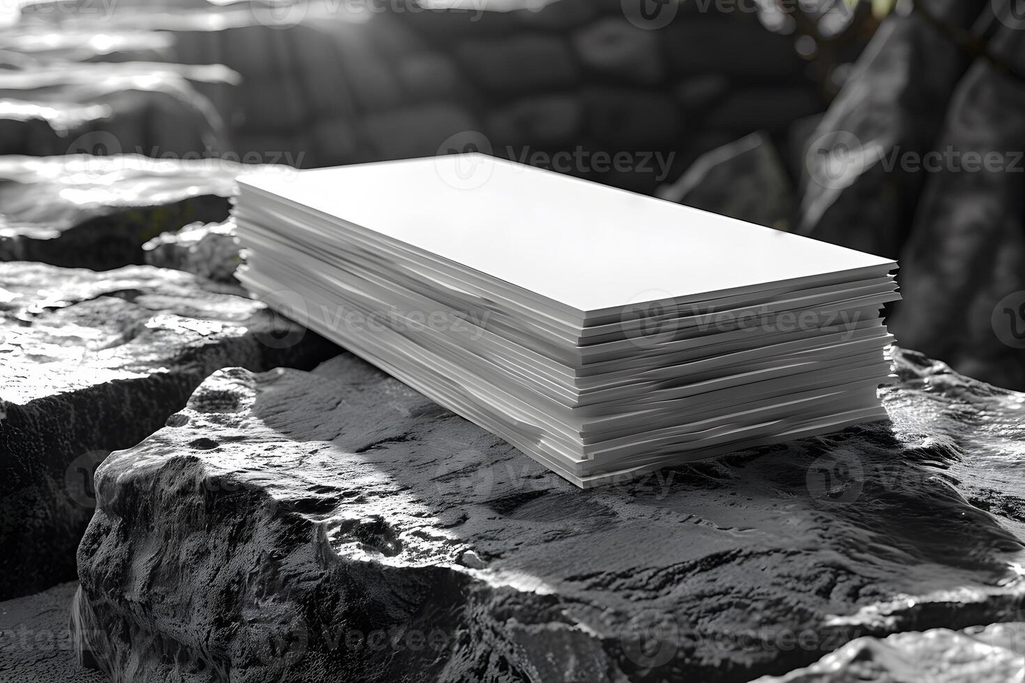 Stack of Blank Paper on Rocky Surface in Sunlight for Graphic Design Inspiration photo