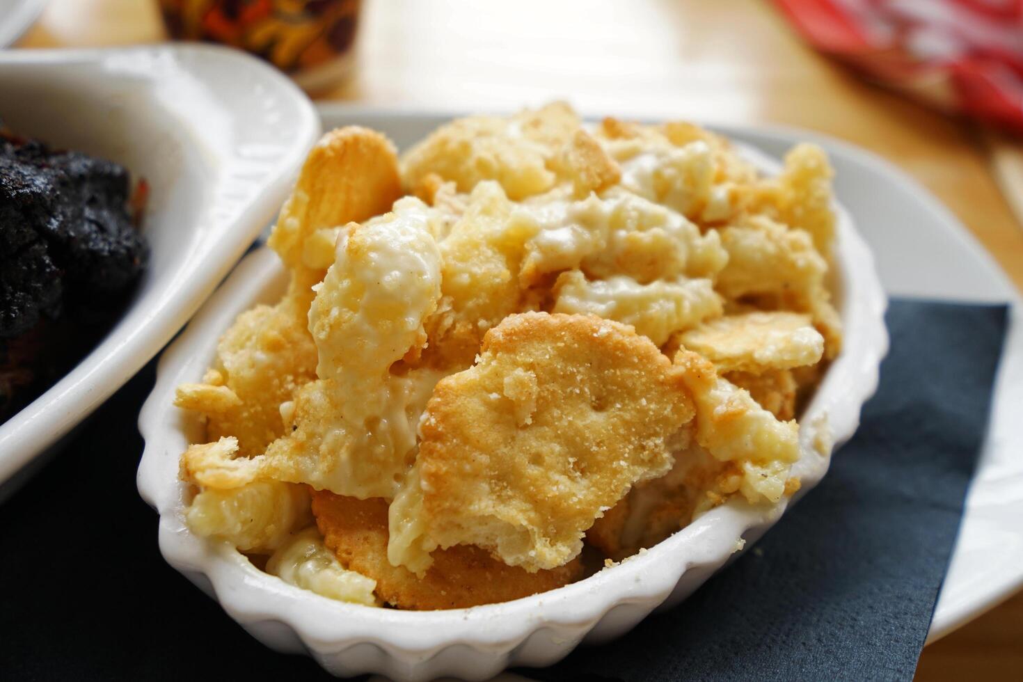 Close up Macaroni and cheese served with crispy crackers photo