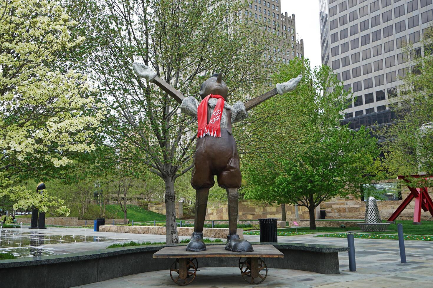 Exterior architecture and design at 'SAINT LOUIS CITY GARDEN' with bronze Pinocchio sculpture stands atop wheeled cart Sculpted in 2009 by Jim Dine- Missouri, United States photo