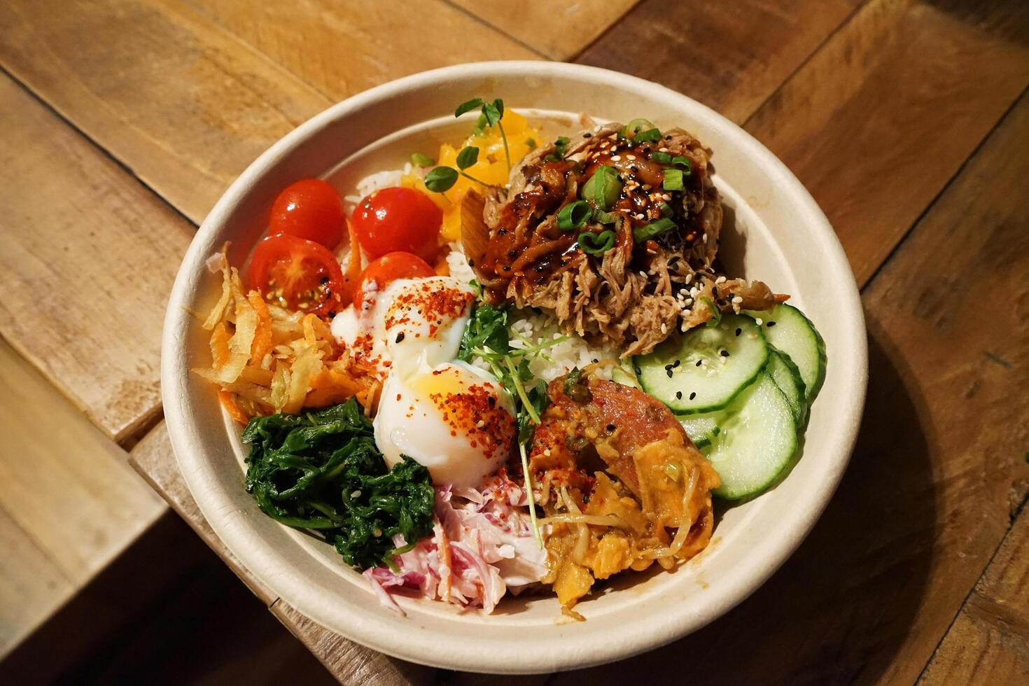 Close up bowl of Barbecue pulled beef on rice with mixed vegetables in Korean style photo