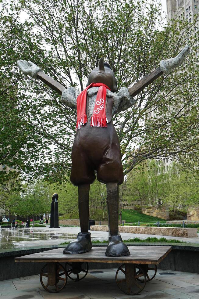 Exterior architecture and design at 'SAINT LOUIS CITY GARDEN' with bronze Pinocchio sculpture stands atop wheeled cart Sculpted in 2009 by Jim Dine- Missouri, United States photo