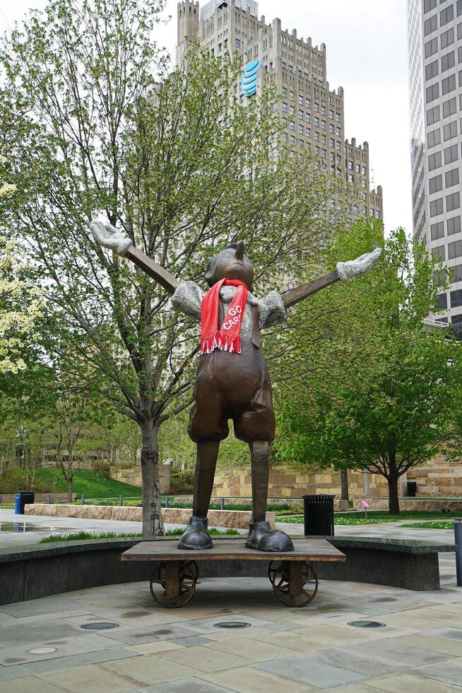 Exterior architecture and design at 'SAINT LOUIS CITY GARDEN' with bronze Pinocchio sculpture stands atop wheeled cart Sculpted in 2009 by Jim Dine- Missouri, United States photo